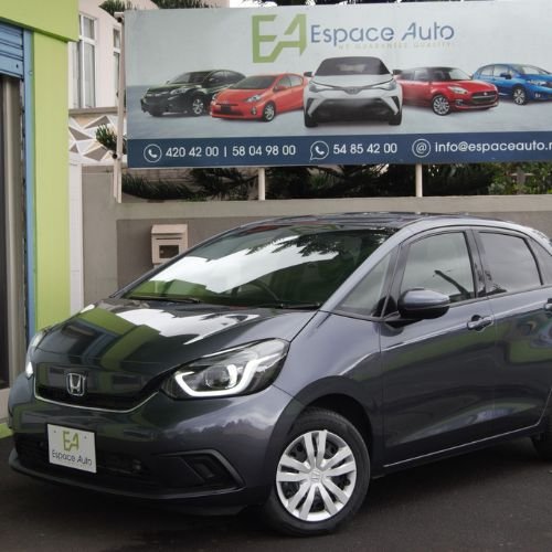 Dark grey Honda Fit at car dealership parking