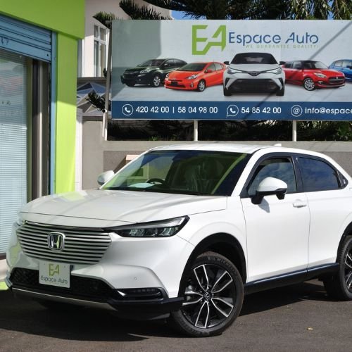 White Honda Vezel hybrid at car dealership parking