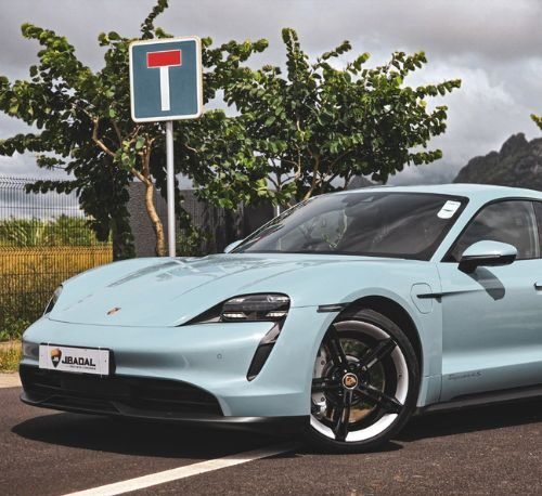 Sky blue Porsche on a parking lot