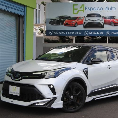 White Toyota CHR Hybrid at car dealership parking