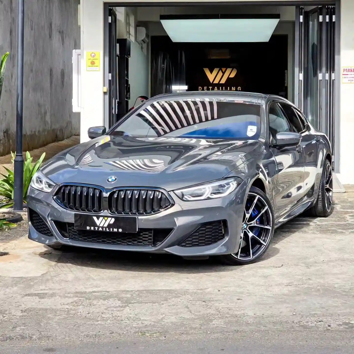 Grey BMW 8 Series outside VIP Detailing workshop post detailing