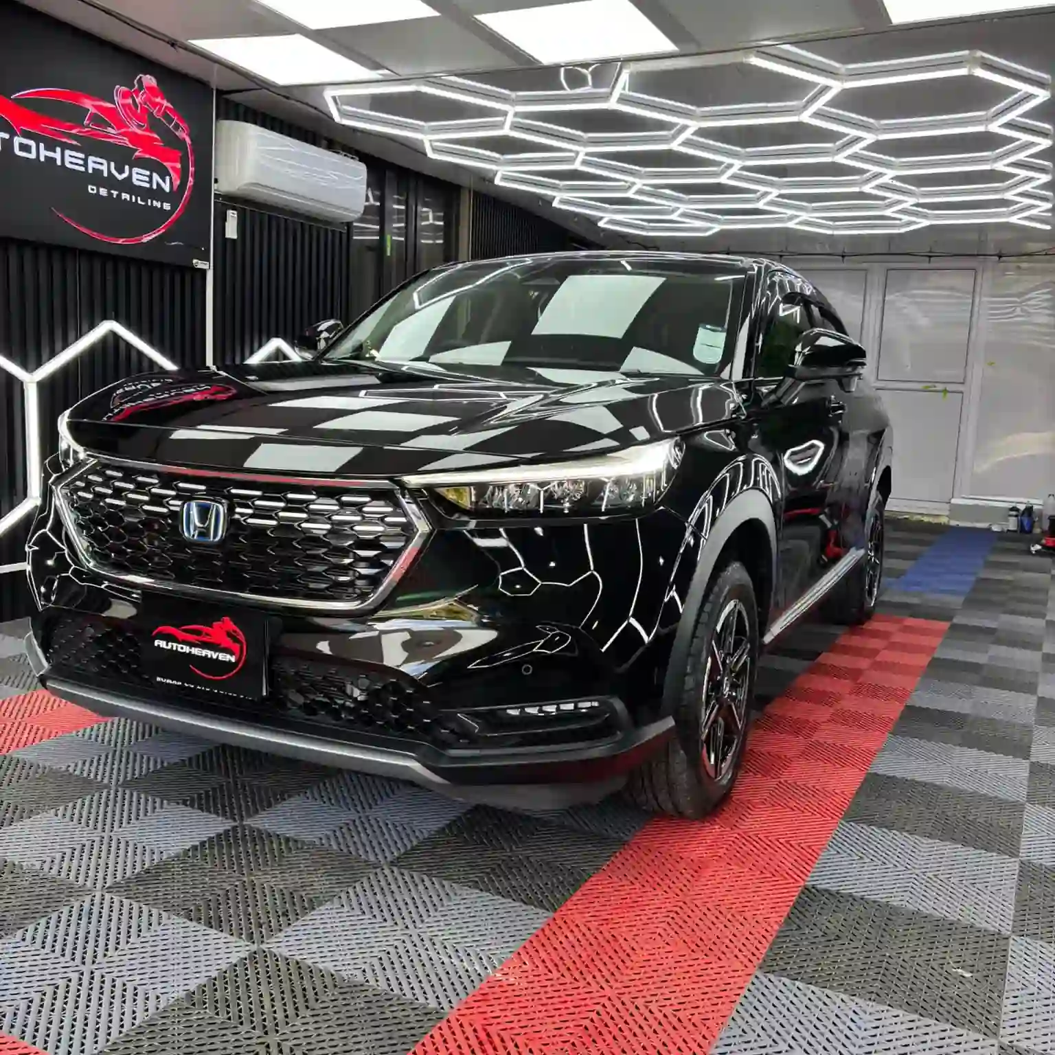 Black Honda Vezel in a detailing workshop