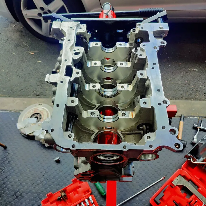 Dismantled engine block mounted on a stand for rebuilding.