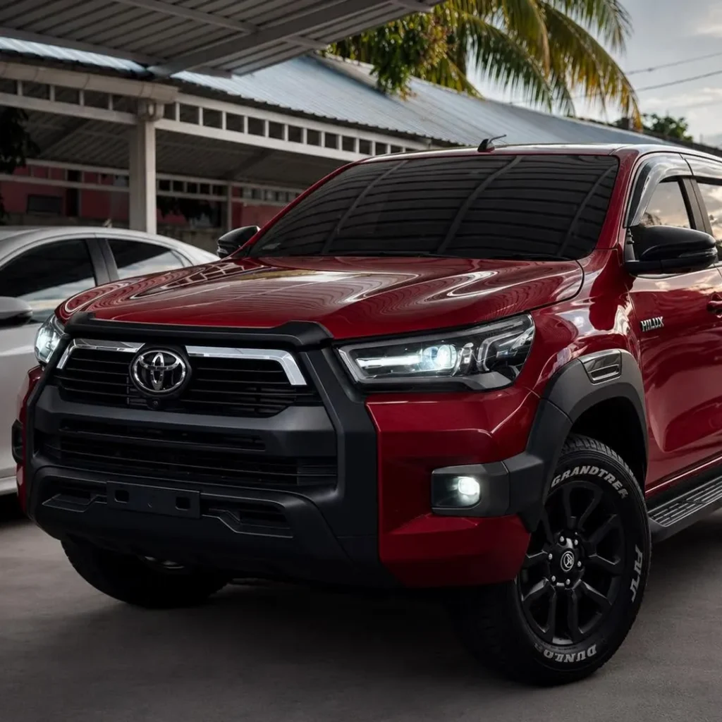 Dark red Toyota Hilux on a car parking