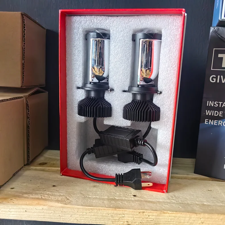 Pair of LED headlight bulbs with cooling fins and wiring in a foam-lined box.