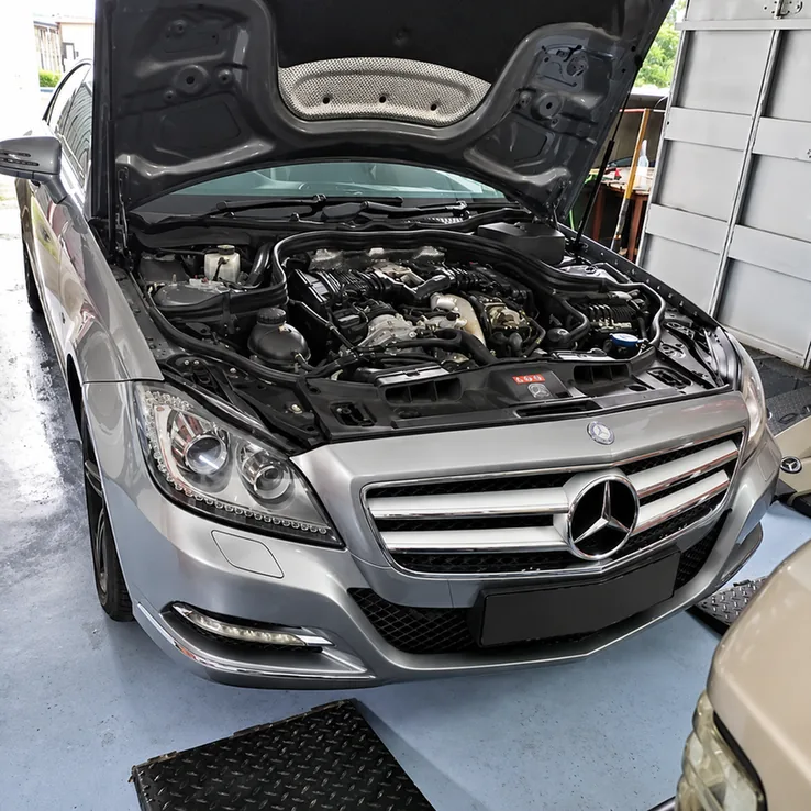 Silver Mercedes-Benz CLS-Class with its bonnet open and engine bay visible.