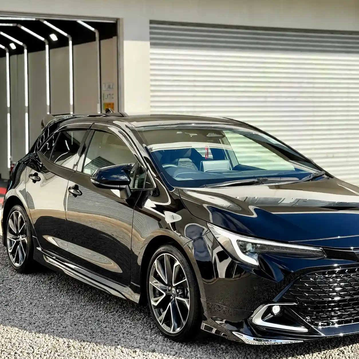 Black Toyota Corolla Sport on a car detailing parking after ceramic coating care