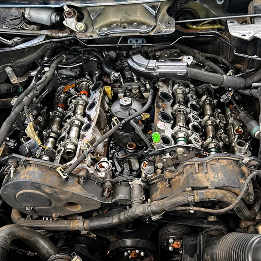 Engine with both valve covers removed, exposing camshafts and surrounding components.